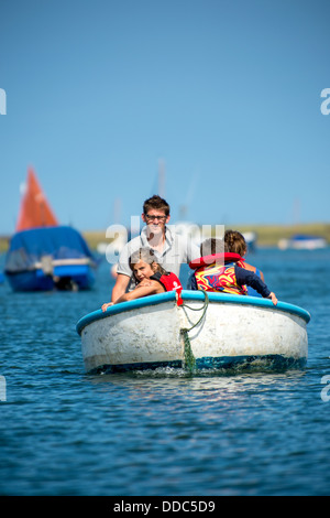 Family pottering in a tender in Blakeney harbour. Stock Photo