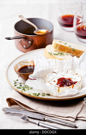 Baked Camembert cheese with thyme and toasted bread Stock Photo