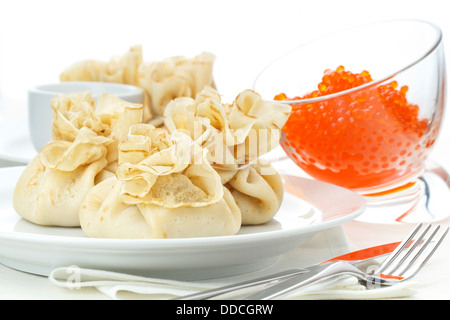 Pancake pouches with red caviar on white background Stock Photo