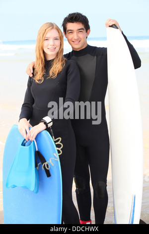 Couple wearing wet-suits Stock Photo