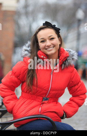 Portrait of a woman smiling with her hands in her pockets, Boston, Suffolk County, Massachusetts, USA Stock Photo