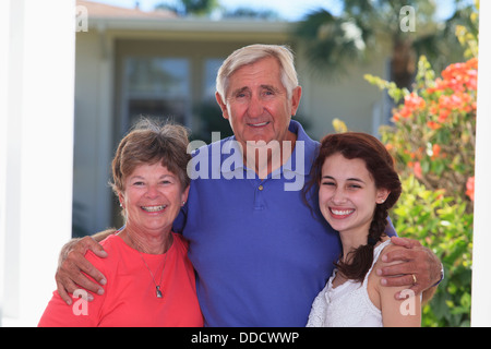 Senior couple standing with their granddaughter Stock Photo