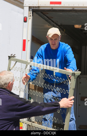 Men loading furniture into a truck Stock Photo