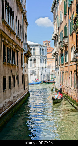 Narrow canal of venice, with multi-color small houses on the side. Stock Photo