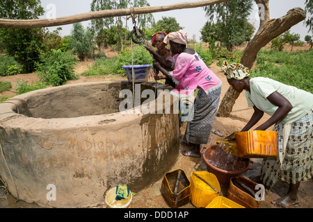 Wolof Women Drawing Water from Well to Irrigate Vegetable Garden. Dialacouna Gardening Project, near Kaolack, Senegal.  An Africare project. Stock Photo