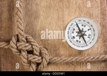 compass and rope knot on a wooden background Stock Photo