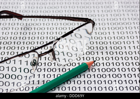 glasses and pencil on the background of a binary code Stock Photo