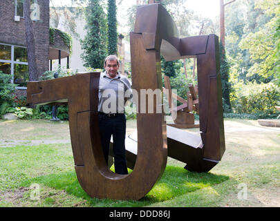 The Berlin sculptor Volker Bartsch stands in an exhibition taking place on occasion of his 60th anniversary in the Georg-Kolbe-Museum in Berlin, Germany, 30 August 2013. Photo: MAURIZIO GAMBARINI Stock Photo