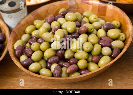 Green and Black Olives in a Bamboo Bowl Stock Photo
