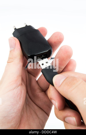 Man using black USB phone charger Stock Photo