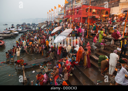 Indian Hindu pilgrims and devotees bathe in Ganges in the morning of one of Diwali festival days in Varanasi, India. 2012 Stock Photo