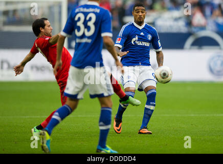 Gelsenkirchen, Germany. 31st Aug, 2013. Schalke's Kevin-Prince Boateng (C) vies for the ball with Leverkusen's Gonzalo Castro (L) during the Bundesliga soccer match between FC Schalke 04 and Bayer 04 Leverkusen at Veltins-Arena in Gelsenkirchen, Germany, 31 August 2013. Photo: ROLF VENNENBERND (PLEASE NOTE: Due to the accreditation guidelines, the DFL only permits the publication and utilisation of up to 15 pictures per match on the internet and in online media during the match.)/dpa/Alamy Live News