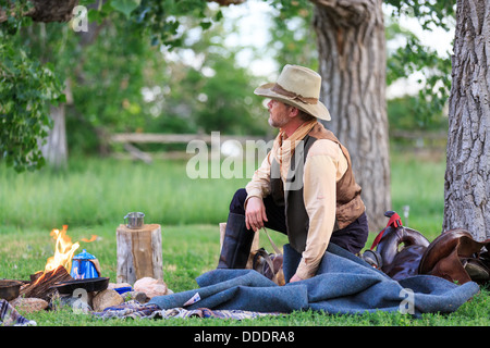 A cowboy preparing and eating breakfast at his campfire Stock Photo