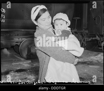 Los Angeles, California. Evacuee mother and child ready to board a train which will take them to an . . . 536772 Stock Photo