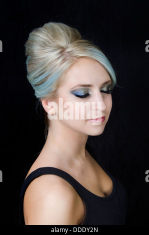 A young beauty model with blue blonde cooltone hair in an elegant up-do in a studio setting Stock Photo