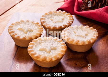 Four Christmas mince pies on a table Stock Photo