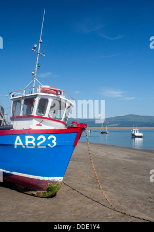 Fishing boat on beach at low tide in estuary Aberdovey Aberdyfi Gwynedd Mid Wales UK Stock Photo