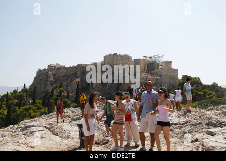 Tourists on the Rock of Areopagos and view of the Acropolis, Athens, Attica, Greece Stock Photo