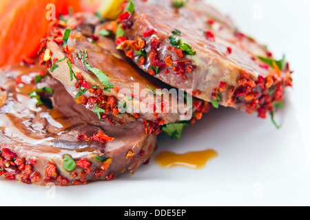 Stewed mutton with spices on a white plate Stock Photo