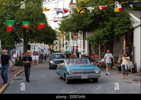 Pedestrians and cars cruising Commercial Street in Provincetown, MA on a summer evening. Stock Photo