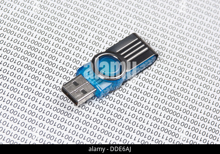 USB flash drive on the background of a binary code Stock Photo