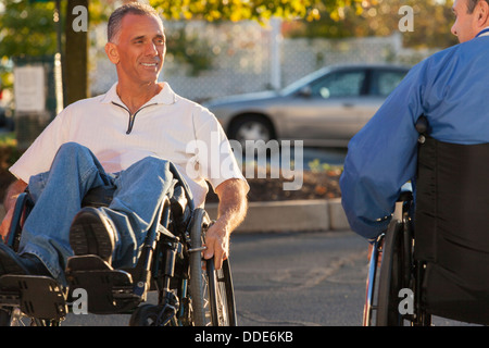 Man with spinal cord injury doing tricks in his wheelchair Stock Photo