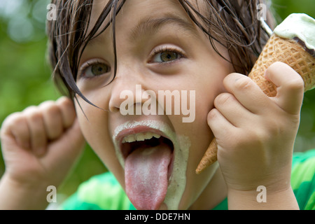 Cute young boy sticks his tongue out Stock Photo