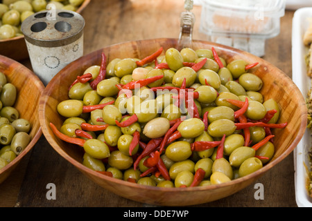 Queen Greek olives stuffed with hot piri-piri peppers in a Bamboo Bowl Stock Photo