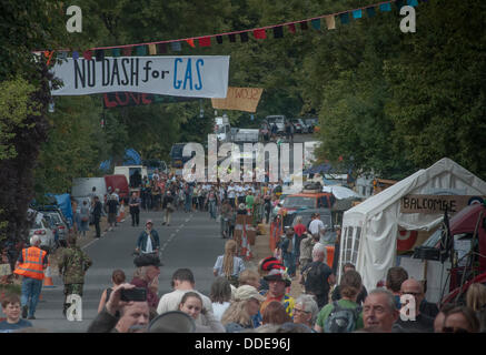 Balcombe,West Sussex, UK. 1st September 2013. 'Belt it out Balcombe', Gathered crowds at this Anti Fracking singing event are joined by Balcombe residents who walked down from the village escorted by Police. The anti fracking environmentalists are protesting against test drilling by Cuadrilla on the site in West Sussex that could lead to the controversial fracking process. The roadside campsite continues to grow in size with more tents arriving daily Credit:  David Burr/Alamy Live News Stock Photo