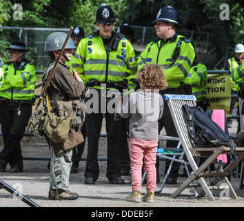 Balcombe, West Sussex, UK. 1st Sep, 2013. Rory and sister talking to Police Officers outside the Cuadrilla site entrance at the 'Belt it out Balcombe event. The anti fracking environmentalists are protesting against test drilling by Cuadrilla on the site in West Sussex that could lead to the controversial fracking process. The roadside campsite continues to grow in size with more tents arriving daily Credit:  David Burr/Alamy Live News Stock Photo