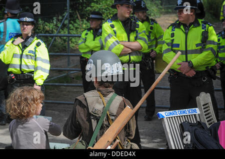 Balcombe, West Sussex, UK. 1st Sep, 2013. Climate crime scene. Rory and sister in front of Police line at Cuadrilla site entrance at 'Belt it out Balcombe' event today.  The anti fracking environmentalists are protesting against test drilling by Cuadrilla on the site in West Sussex that could lead to the controversial fracking process. The roadside campsite continues to grow in size with more tents arriving daily Stock Photo