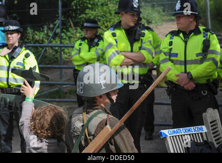 Balcombe, West Sussex, UK. 1st Sep, 2013. Climate crime scene. Rory and sister in front of Police line at Cuadrilla site entrance at 'Belt it out Balcombe' event today.  The anti fracking environmentalists are protesting against test drilling by Cuadrilla on the site in West Sussex that could lead to the controversial fracking process. The roadside campsite continues to grow in size with more tents arriving daily Stock Photo