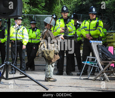 Rory Rush at 'Belt it out Balcombe' event. Playing with model aircraft in front of Police lines at Cuadrilla site entrance, speaker set  ready for sound check....   The anti fracking environmentalists are protesting against test drilling by Cuadrilla on the site in West Sussex that could lead to the controversial fracking process. The roadside campsite continues to grow in size with more tents arriving daily Stock Photo