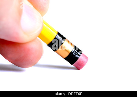 Fingers holding a pencil by the eraser end isolated on white Stock Photo