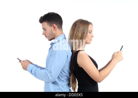 Attractive couple typing in their mobile phones isolated on a white background Stock Photo