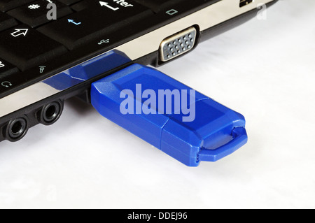 Blue USB stick plugged into netbook. Stock Photo