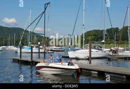 Family in speedboat at Ferry Nab, Lake Windermere, Bowness, Lake District National Park, Cumbria, England UK Stock Photo