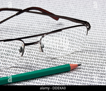 glasses and pencil on the background of a binary code Stock Photo