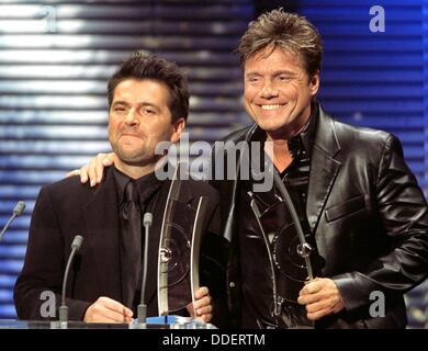 Thomas Anders (l) and Dieter Bohlen (r) alias 'Modern Talking' receive the Echo Award on the 4th of March in 1999 after their sensational comeback. Stock Photo