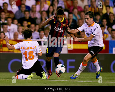 Valencia, Spain. 01st Sep, 2013. Forward Neymar of FC Barcelona (C) takes on Midfielder Andres Guardado of Valencia CF (L) and Midfielder Michel of Valencia CF during the Spanish La Liga game between Valencia and Barcelona from the Mestalla Stadium. Credit:  Action Plus Sports/Alamy Live News Stock Photo