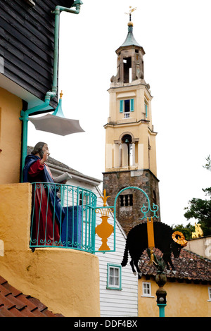 Statue figure, with iron sign of black sheep / ram on the Toll House, Battery Square and clock / bell tower in background Stock Photo