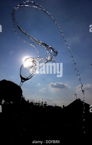 Water splashing from wine glass Stock Photo