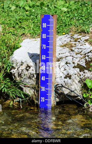 Water level marker in a river Stock Photo