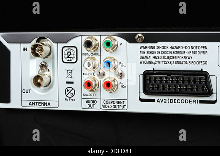 RCA/phono sockets on rear of video/HDD appliance against a black background. Stock Photo