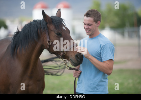 Student and horse in pasture Stock Photo