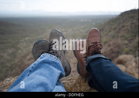 Feet of man and woman resting in the desert after hike, Tucson AZ Stock Photo