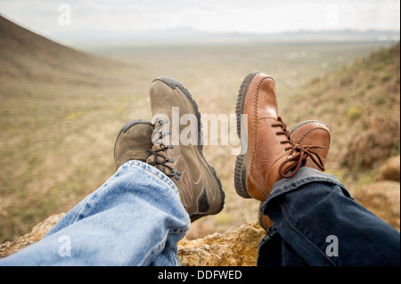 Feet of man and woman resting in the desert after hike, Tucson AZ Stock Photo