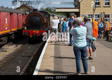 Enthusiasts watch the arrival of a steam train at Wansford Station on the Nene Valley Railway. Stock Photo