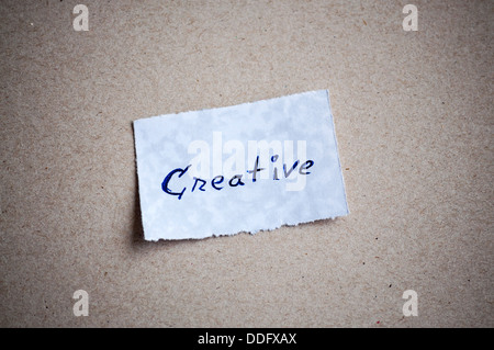 Creative message,written on piece of paper, on cardboard background. Space for your text Stock Photo