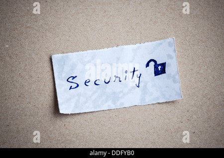 Security message,written on piece of paper, on cardboard background. Space for your text. Stock Photo
